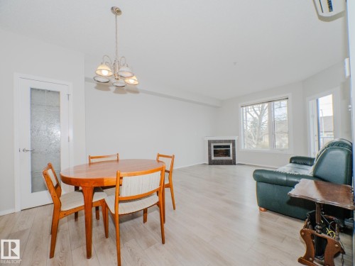 209 12111 51 Avenue, Edmonton, AB - Indoor Photo Showing Dining Room With Fireplace