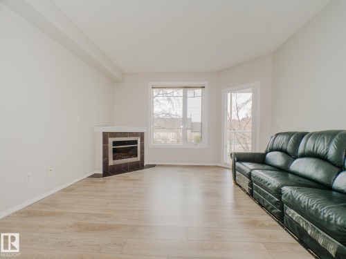 209 12111 51 Avenue, Edmonton, AB - Indoor Photo Showing Living Room With Fireplace