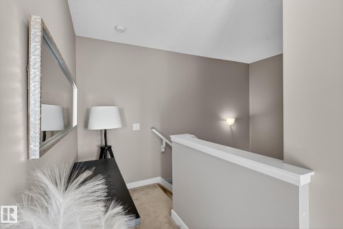Corridor featuring an upstairs landing and light colored carpet - 117 7293 South Terwillegar Drive, Edmonton, AB - Indoor Photo Showing Other Room