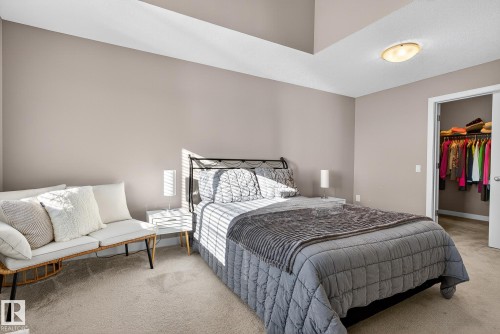 Carpeted bedroom featuring a walk in closet - 117 7293 South Terwillegar Drive, Edmonton, AB - Indoor Photo Showing Bedroom