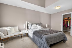 Carpeted bedroom featuring a walk in closet - 