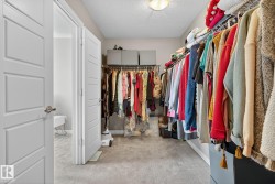 Walk in closet featuring light colored carpet - 