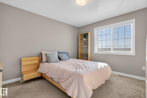 Carpeted bedroom featuring baseboards and a textured ceiling - 117 7293 South Terwillegar Drive, Edmonton, AB - Indoor Photo Showing Bedroom