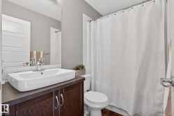 Full bath with vanity, a shower with shower curtain, and dark tile patterned flooring - 