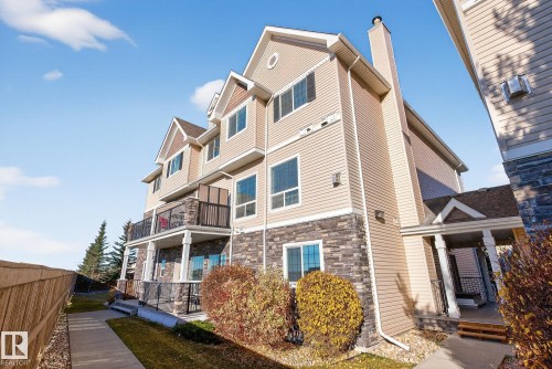 Back of house with stone siding and a chimney - 117 7293 South Terwillegar Drive, Edmonton, AB - Outdoor With Balcony