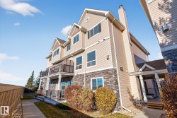 Back of house with stone siding and a chimney - 