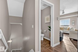 Ensuite bathroom with wood finished floors, ceiling fan, and a textured ceiling - 