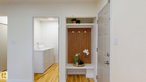 Washroom with light wood-style floors and washing machine and clothes dryer - 114 2908 116A Avenue, Edmonton, AB - Indoor Photo Showing Other Room