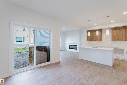 358 Bluff Cove, Leduc, AB - Indoor Photo Showing Kitchen With Fireplace