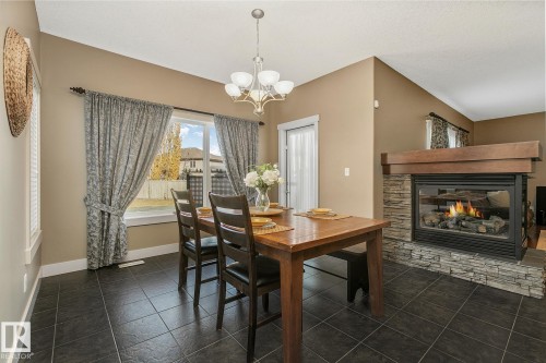 1110 Connelly Court, Edmonton, AB - Indoor Photo Showing Dining Room With Fireplace