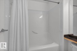Bathroom with toilet and shower / bathtub combination with curtain - 