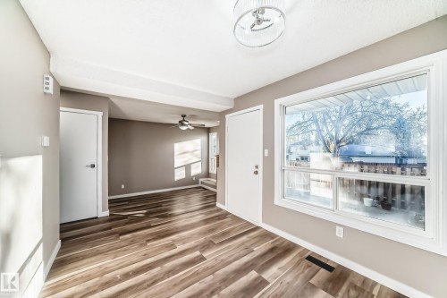 Unfurnished living room with light wood-style flooring and ceiling fan - 44 4403 Riverbend Road, Edmonton, AB - Indoor Photo Showing Other Room
