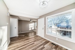 Unfurnished living room with light wood-style flooring and ceiling fan - 
