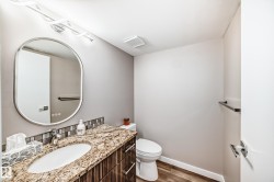 Half bathroom with dark wood-type flooring and vanity - 