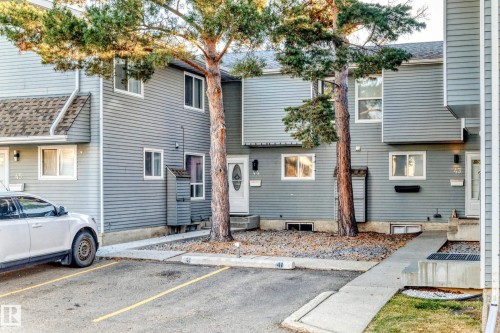 Rear view of property featuring uncovered parking - 44 4403 Riverbend Road, Edmonton, AB - Outdoor
