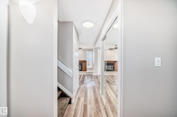 Hallway with stairs and light wood finished floors - 