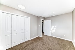 Unfurnished bedroom with attic access, a closet, and carpet flooring - 