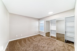 Unfurnished bedroom with a closet and dark colored carpet - 