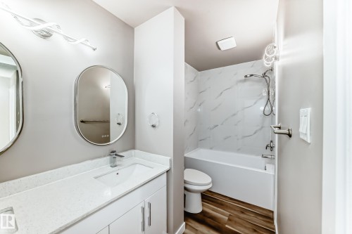 Full bathroom with double vanity, wood finished floors, and tub / shower combination - 44 4403 Riverbend Road, Edmonton, AB - Indoor Photo Showing Bathroom