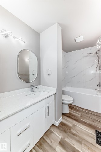 Bathroom with vanity, light wood-type flooring, and shower / tub combination - 44 4403 Riverbend Road, Edmonton, AB - Indoor Photo Showing Bathroom