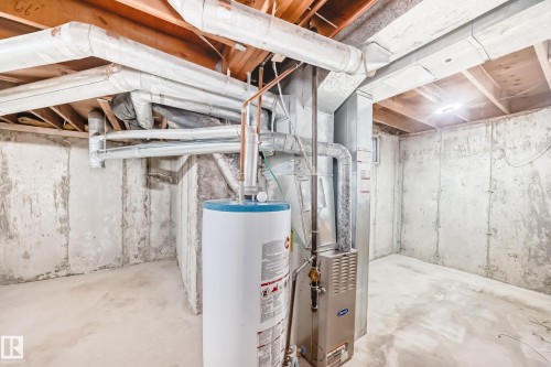 Unfinished below grade area with gas water heater and heating unit - 44 4403 Riverbend Road, Edmonton, AB - Indoor Photo Showing Basement