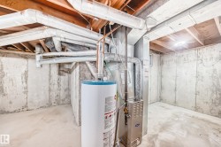 Unfinished below grade area with gas water heater and heating unit - 