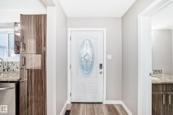 Foyer featuring baseboards and light wood finished floors - 