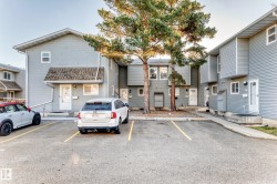 View of building exterior with uncovered parking - 