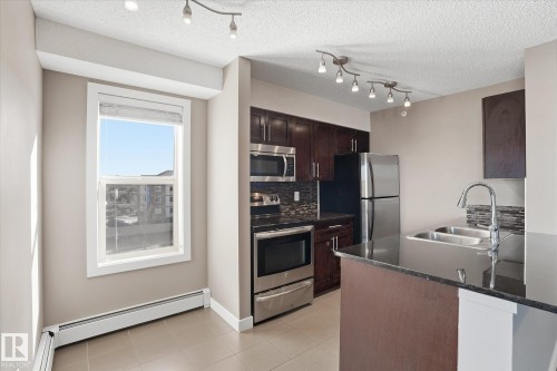 402 11803 22 Avenue, Edmonton, AB - Indoor Photo Showing Kitchen With Stainless Steel Kitchen With Double Sink