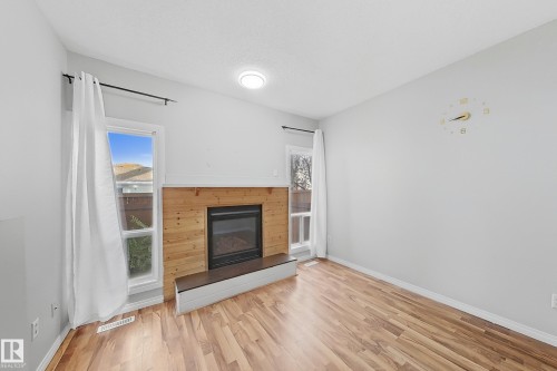 24 3812 20 Avenue, Edmonton, AB - Indoor Photo Showing Living Room With Fireplace