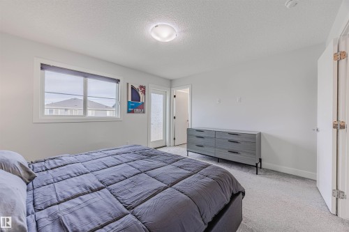 Bedroom featuring a textured ceiling and carpet - 8086 Kiriak Link, Edmonton, AB - Indoor Photo Showing Bedroom