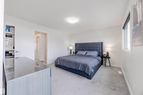 Bedroom with light carpet and baseboards - 8086 Kiriak Link, Edmonton, AB - Indoor Photo Showing Bedroom