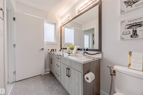 Bathroom with double vanity and light marble finish flooring - 8086 Kiriak Link, Edmonton, AB - Indoor Photo Showing Bathroom