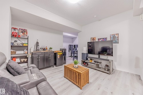 Living room with light wood-style flooring and a textured ceiling - 8086 Kiriak Link, Edmonton, AB - Indoor Photo Showing Living Room