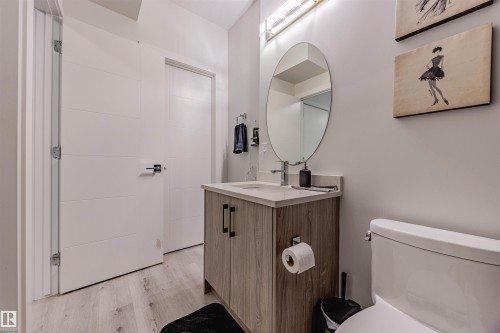 Half bathroom with light wood-style flooring and vanity - 8086 Kiriak Link, Edmonton, AB - Indoor Photo Showing Bathroom