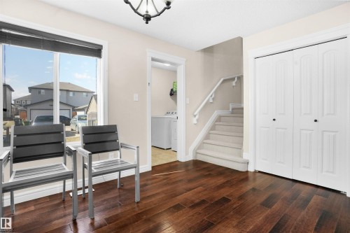 Foyer entrance featuring dark wood-style flooring and stairway - 1442 33A Street Nw, Edmonton, AB - Indoor Photo Showing Other Room