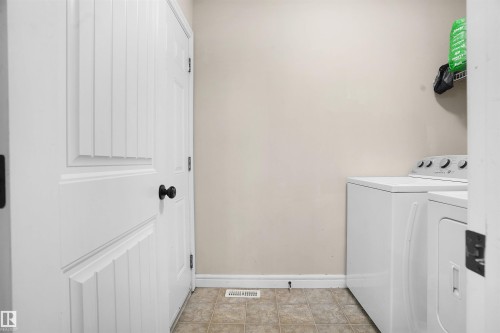 Laundry room with washer and dryer and light tile patterned floors - 1442 33A Street Nw, Edmonton, AB - Indoor Photo Showing Laundry Room