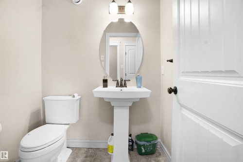 Bathroom with tile patterned floors and baseboards - 1442 33A Street Nw, Edmonton, AB - Indoor Photo Showing Bathroom