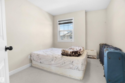 Bedroom featuring carpet and baseboards - 1442 33A Street Nw, Edmonton, AB - Indoor Photo Showing Bedroom