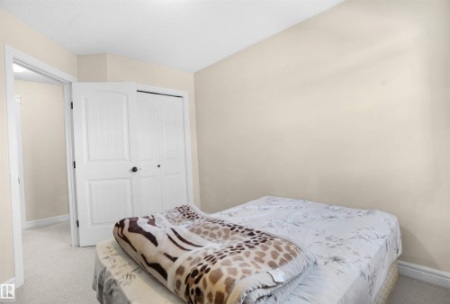 Carpeted bedroom with baseboards and a closet - 1442 33A Street Nw, Edmonton, AB - Indoor Photo Showing Bedroom