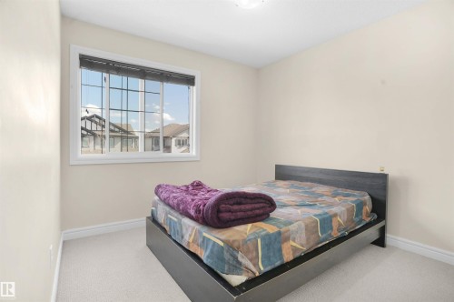 Carpeted bedroom with baseboards - 1442 33A Street Nw, Edmonton, AB - Indoor Photo Showing Bedroom