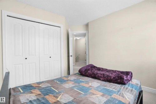 Carpeted bedroom with a closet and baseboards - 1442 33A Street Nw, Edmonton, AB - Indoor Photo Showing Bedroom