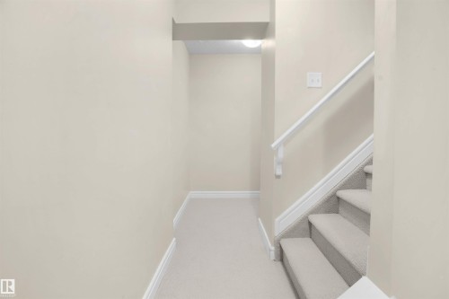 Staircase with baseboards and carpet floors - 1442 33A Street Nw, Edmonton, AB - Indoor Photo Showing Other Room