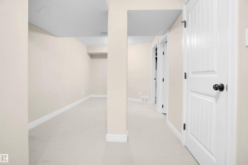 Below grade area featuring light carpet and baseboards - 1442 33A Street Nw, Edmonton, AB - Indoor Photo Showing Other Room