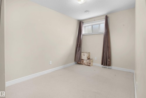 Unfurnished room with carpet and a textured ceiling - 1442 33A Street Nw, Edmonton, AB - Indoor Photo Showing Other Room