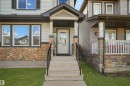 Entrance to property featuring stone siding and covered porch - 1442 33A Street Nw, Edmonton, AB  - Outdoor 