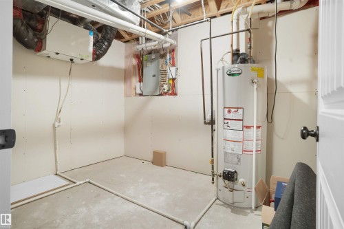 Utilities featuring gas water heater and electric panel - 1442 33A Street Nw, Edmonton, AB - Indoor Photo Showing Basement