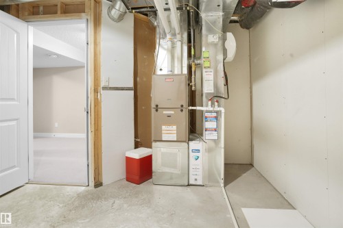 Utilities featuring heating unit - 1442 33A Street Nw, Edmonton, AB - Indoor Photo Showing Basement
