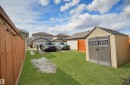 View of grassy yard with a storage shed and a residential view - 1442 33A Street Nw, Edmonton, AB  - Outdoor 