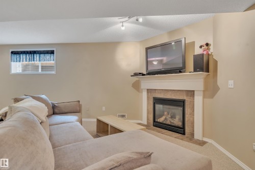 6 102 Bridgeport Crossing, Leduc, AB - Indoor Photo Showing Living Room With Fireplace